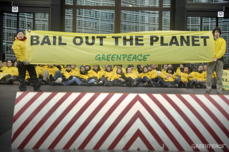 Brussels, 10 March 2009. Greenpeace blocks ‘easy way out’ for EU finance ministers. Hundreds of Greenpeace activists from across Europe have blocked the exits of the Brussels building where EU finance ministers are discussing funding for developing nations to tackle climate change. Activists displayed banners in several languages asking EU politicians to “Sav€ the Climate” and “Bail out the Planet”. The Greenpeace activists ‘sealed’ the building and called on ministers not to come out without money on the table to tackle climate change, rather than to continue dishing out billions of taxpayers’ money for failed banks and carmakers. Police moved in to make arrests. © Eric de Mildt/ Greenpeace.